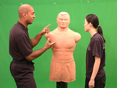 Wing Chun teaching using the 'Bob' dummy.  Are Mark Phillips is discussing pressure lints.