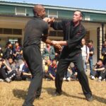 James Sinclair teaching in Hong Kong to a large outdoor audience at the 2nd World VTAA Conference. He was assisted by Master Mark Phillips of the London Wing Chun Academy. 2005. James was teaching ideas when you cant retreat.