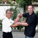 2005 Foshan China. James Sinclair and Master Fung Man pose in Chi Sau.